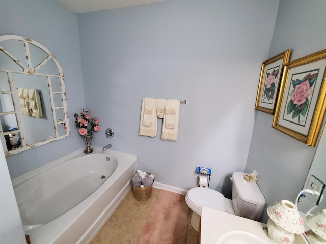 bathroom featuring toilet, tile patterned flooring, baseboards, and a bath