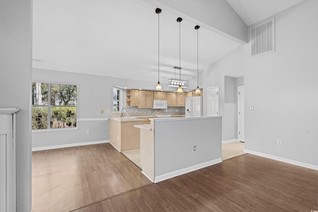 kitchen featuring white appliances, visible vents, light wood-style flooring, light countertops, and light brown cabinets