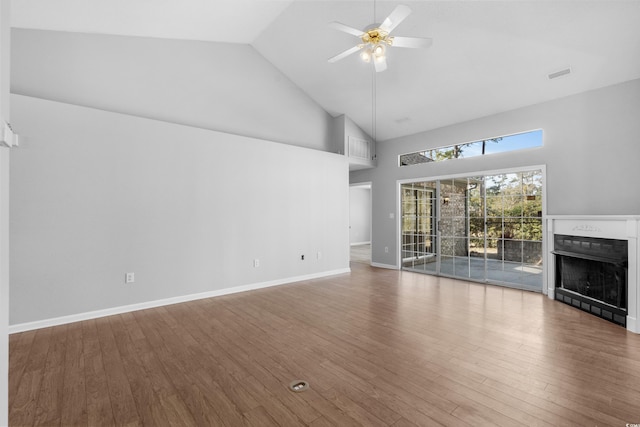 unfurnished living room featuring visible vents, a ceiling fan, wood finished floors, a fireplace, and high vaulted ceiling