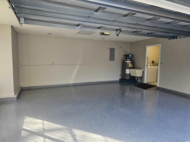 garage featuring water heater, a sink, washer / dryer, electric panel, and baseboards