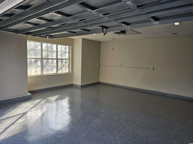 empty room with baseboards and speckled floor