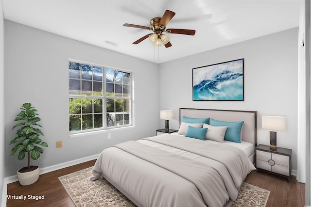 bedroom featuring baseboards, visible vents, ceiling fan, and dark wood-type flooring