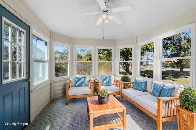 sunroom / solarium featuring ceiling fan