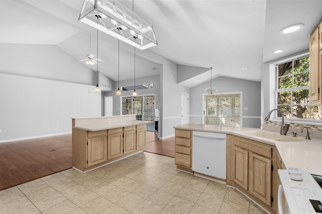 kitchen with lofted ceiling with skylight, ceiling fan, white dishwasher, light countertops, and a sink