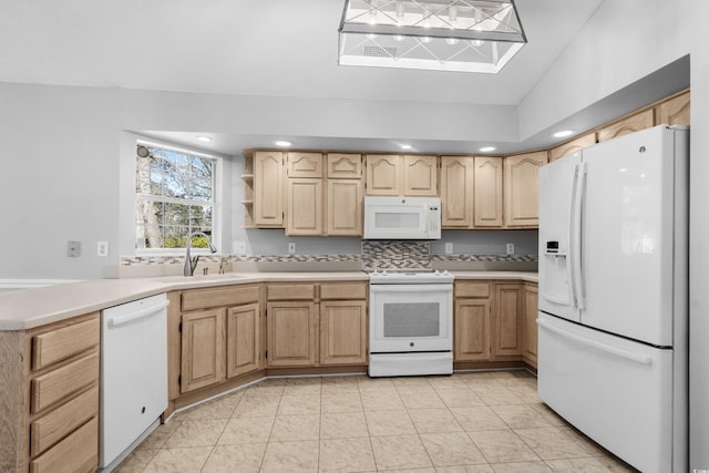 kitchen featuring white appliances, light countertops, light brown cabinetry, open shelves, and a sink