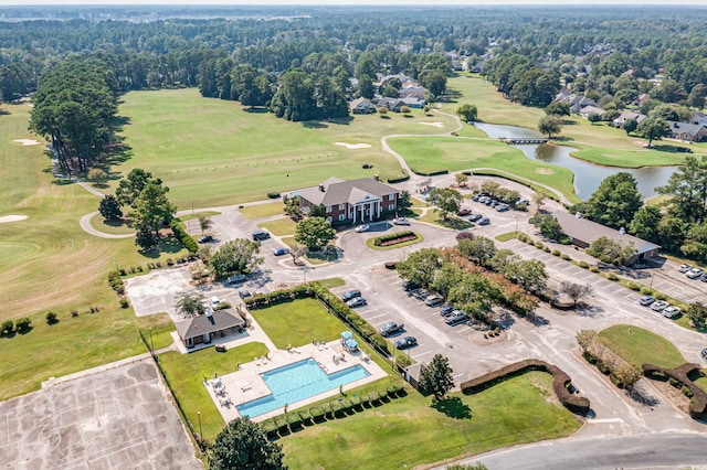 drone / aerial view with a water view and golf course view