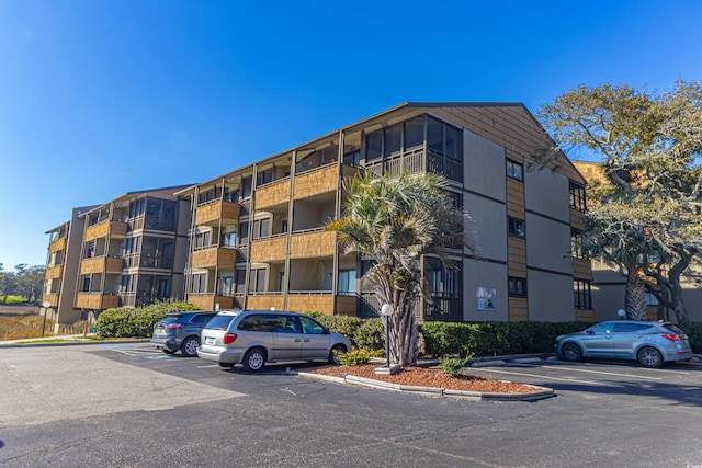 view of building exterior with uncovered parking