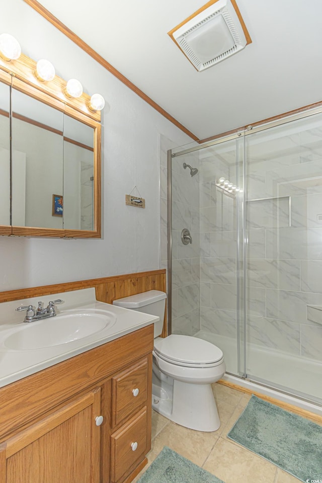 bathroom featuring toilet, vanity, visible vents, a stall shower, and crown molding