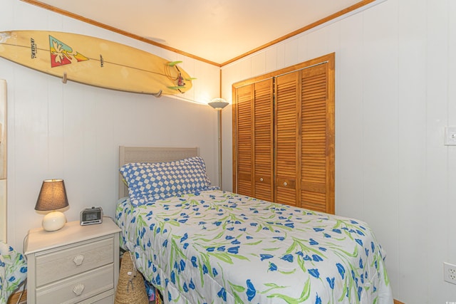 bedroom featuring a closet and crown molding