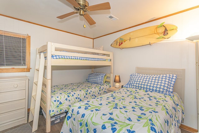 bedroom with ceiling fan, visible vents, wood finished floors, and ornamental molding