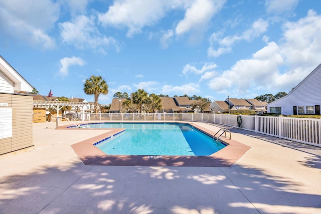 pool featuring a patio area, fence, a residential view, and a pergola