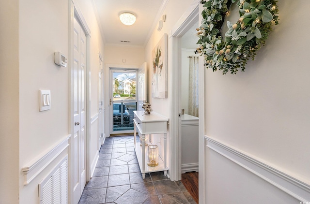 hallway with visible vents and ornamental molding