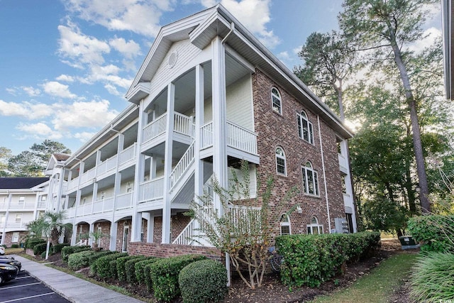 view of building exterior with uncovered parking