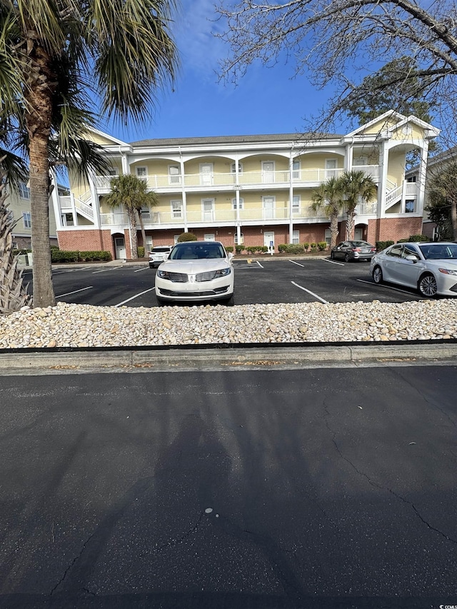 view of property featuring uncovered parking