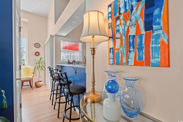 interior space with a textured ceiling and wood finished floors