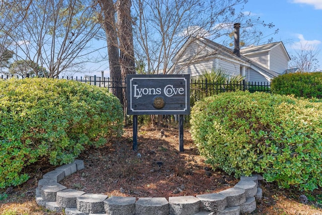 community sign featuring fence