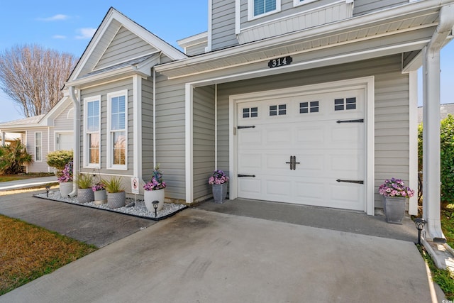 view of exterior entry featuring driveway