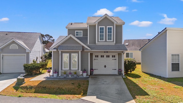 view of front of house with a garage, driveway, a front lawn, and a shingled roof