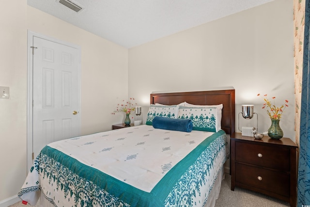 bedroom featuring light carpet and visible vents