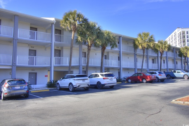 view of property featuring uncovered parking