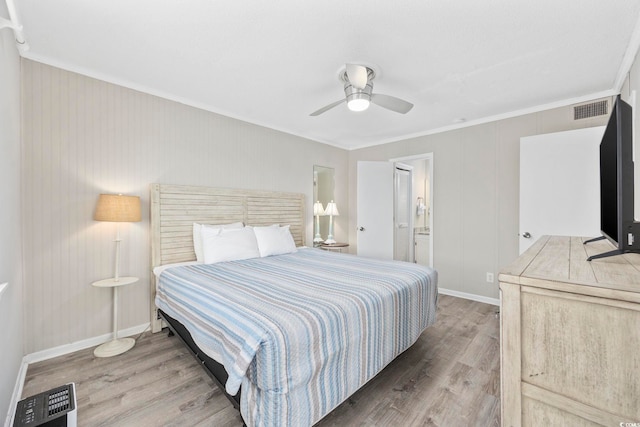 bedroom with ceiling fan, wood finished floors, visible vents, baseboards, and ornamental molding