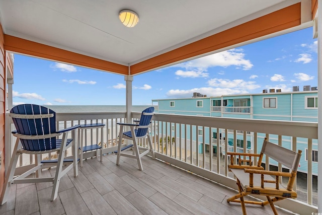 deck featuring a water view and a view of the beach