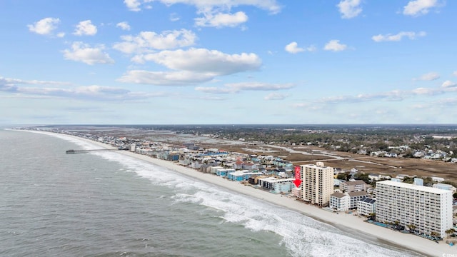 aerial view featuring a water view, a view of city, and a beach view