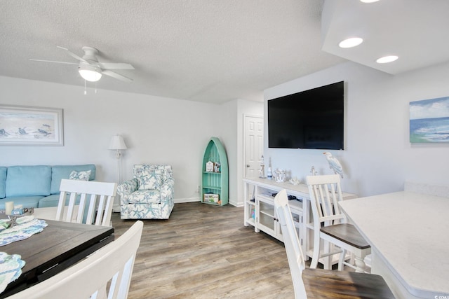 bedroom featuring a ceiling fan, a textured ceiling, wood finished floors, recessed lighting, and baseboards