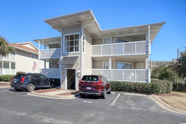 view of property featuring uncovered parking