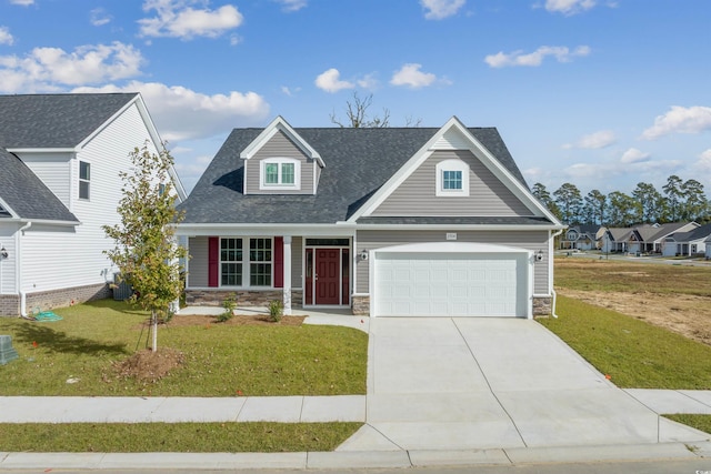 view of front facade with stone siding, driveway, an attached garage, and a front yard