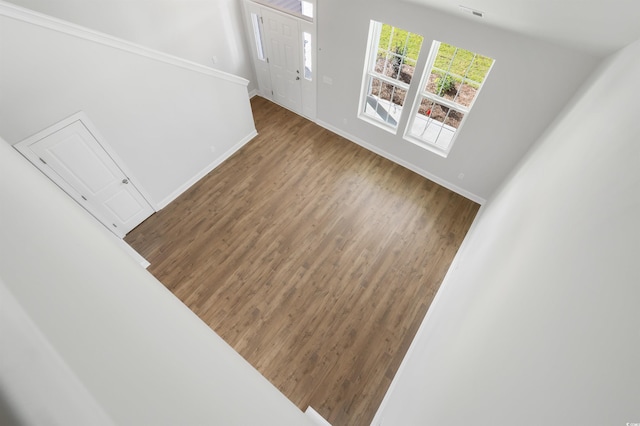 interior space with baseboards and wood finished floors