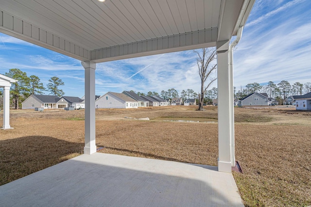 view of yard featuring a residential view and a patio
