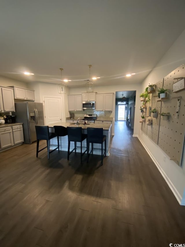 dining area featuring dark wood-type flooring and baseboards