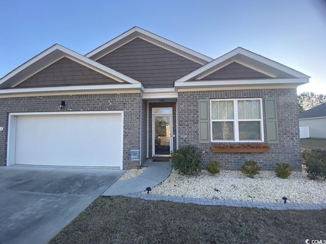 view of front facade with a garage, brick siding, and driveway