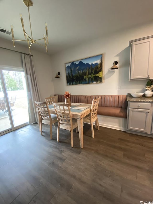 dining space featuring a chandelier, dark wood-style flooring, and visible vents