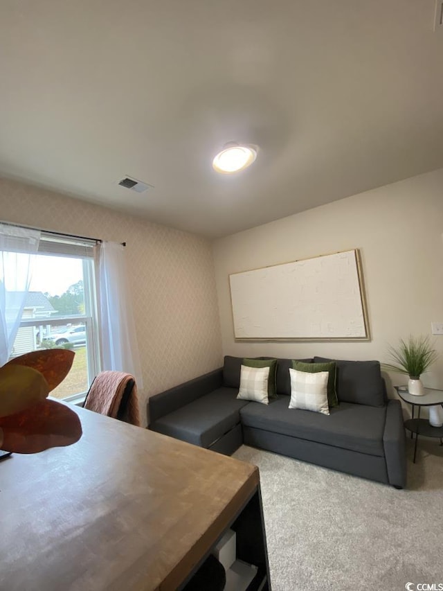 living room featuring light carpet and visible vents