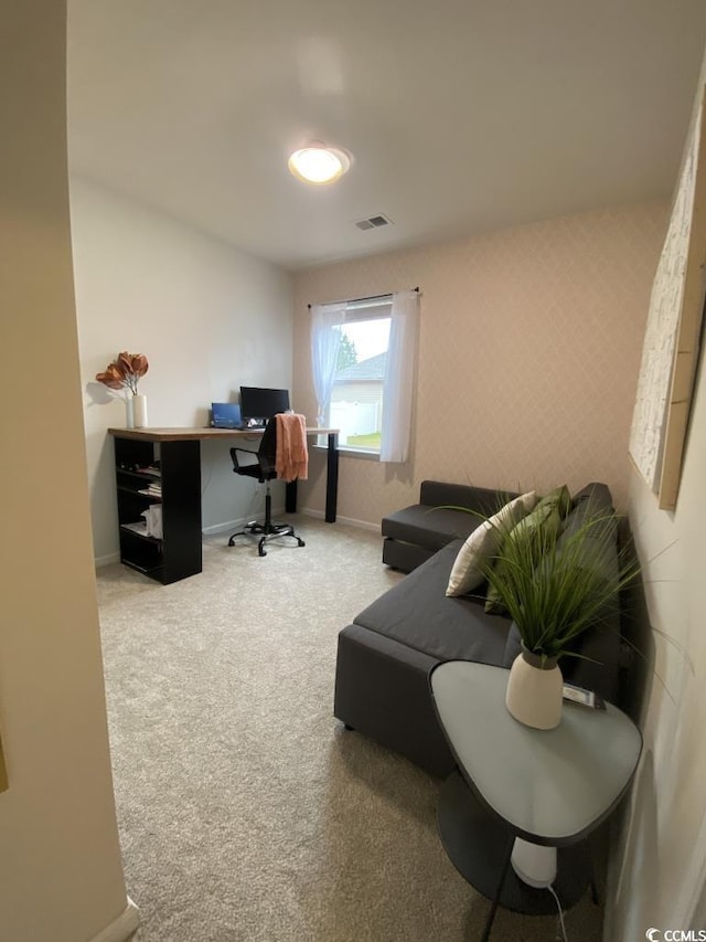 carpeted office space with wallpapered walls, visible vents, and baseboards