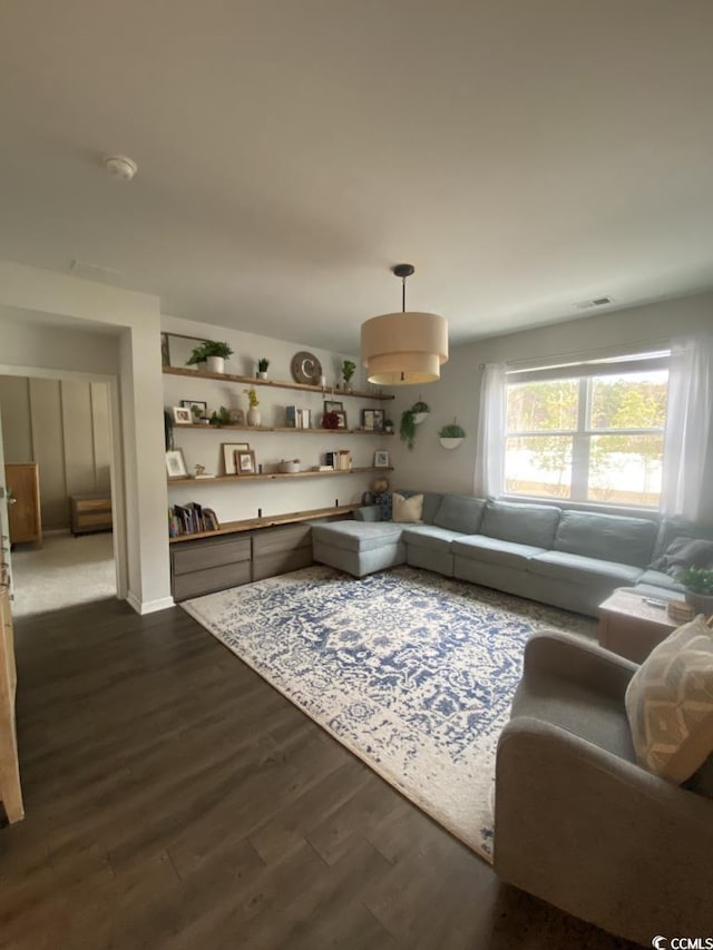 living room with dark wood-type flooring and visible vents