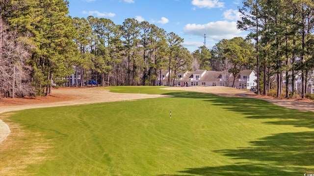 view of home's community featuring a lawn and golf course view