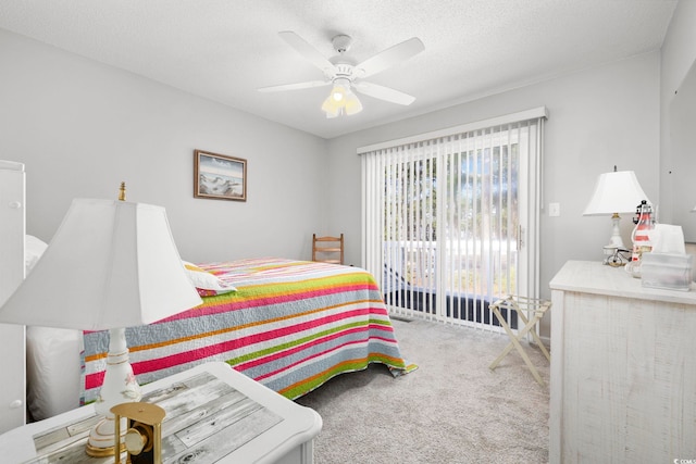 bedroom with a textured ceiling, carpet flooring, and a ceiling fan