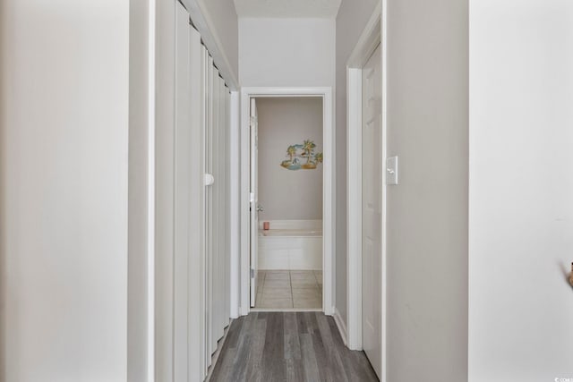 corridor with dark wood-style flooring