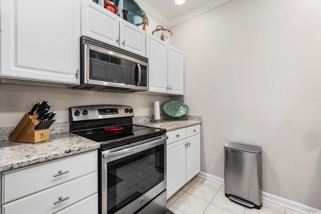 kitchen featuring appliances with stainless steel finishes, white cabinets, and light stone counters