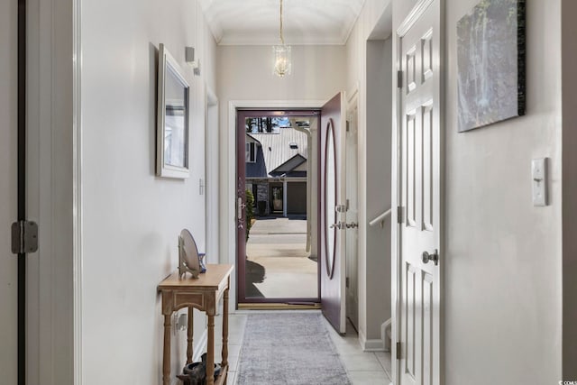 hall featuring ornamental molding and light tile patterned flooring