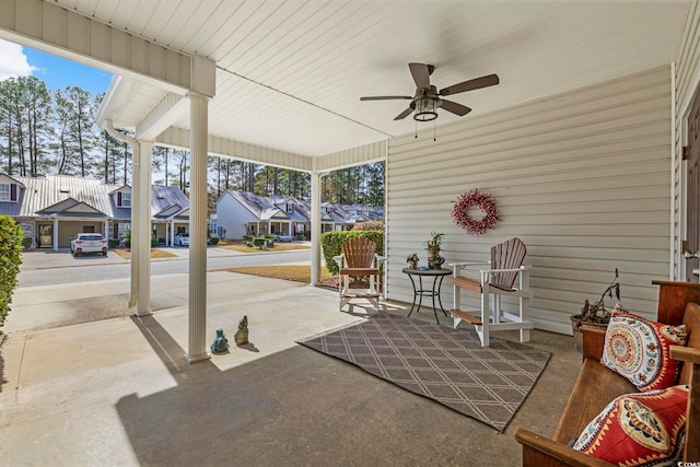 view of patio featuring a porch, a residential view, and ceiling fan