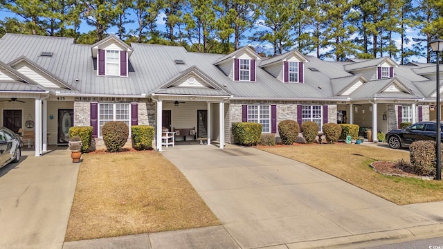 view of front of property with metal roof, brick siding, and a ceiling fan