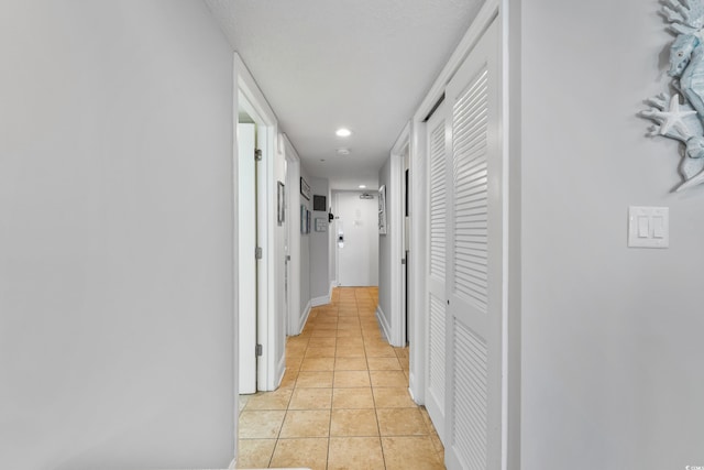 corridor with recessed lighting and light tile patterned floors