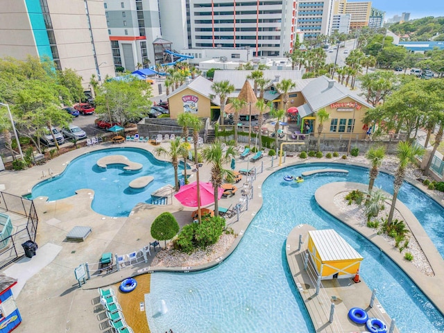 community pool featuring a patio area and a water play area