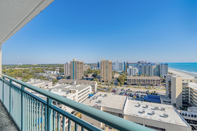 balcony with a water view, a view of city, and a beach view