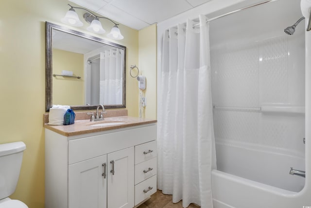 bathroom featuring toilet, vanity, shower / bath combo with shower curtain, and tile patterned floors