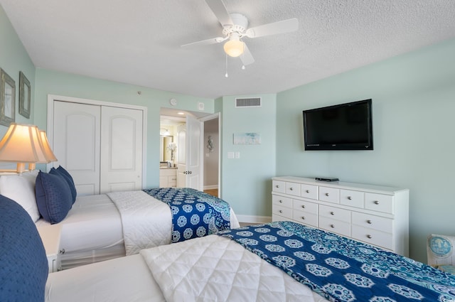 bedroom featuring a closet, visible vents, ceiling fan, a textured ceiling, and baseboards